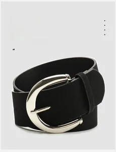 Macro detail of high-quality black PU leather belt with round silver buckle