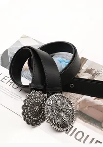 Detail of western vintage belts with ornate silver floral buckles and rhinestone inlay