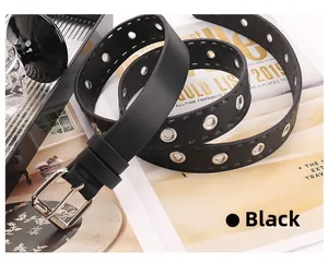 Detail of black punk style belt with silver pin buckle and double rows of metal eyelets