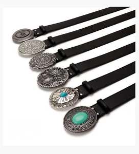 Detail view of six black leather belts with engraved vintage western buckles and turquoise stones