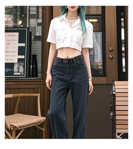 Detail of a black double grommet eyelet belt on high waist jeans for hip hop style