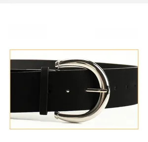 Detailed close-up of a vintage black PU leather belt with polished silver alloy buckle