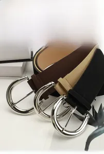 Close-up of PU suede leather belts with silver D-buckles in brown, khaki and black