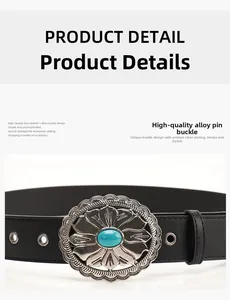 Detail of western floral alloy buckle with turquoise stone on vintage black leather belt