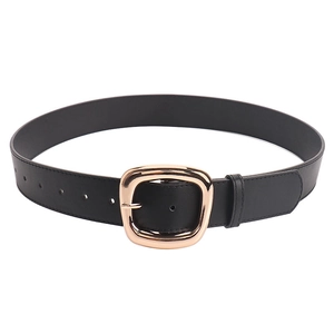 Minimalist black faux leather belt for women featuring a large golden rectangular buckle