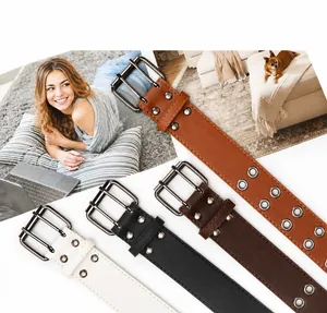 Close-up of four double-grommet belts in white, black, brown, and tan faux leather