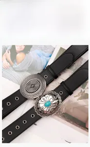 Detail of bohemian black belts with vintage silver buckles and turquoise floral accents