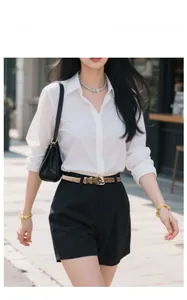 Khaki leather belt with gold horseshoe buckle styled with black high waist shorts