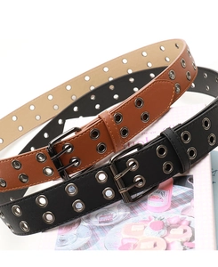 Detail view of punk style double grommet PU leather belts in black and brown colors