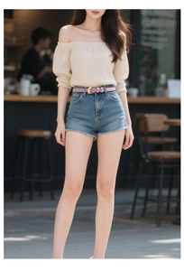 Fashionable pink skinny leather belt with gold horseshoe buckle on high waist denim shorts