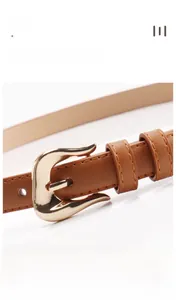 Detail of a brown leather belt featuring a gold alloy buckle and double stitching