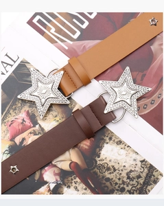 Detail of vintage punk star buckle belts in brown leather with metal rivets decoration