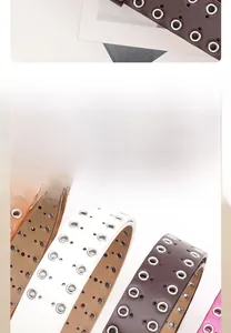 Close-up of punk style PU leather belts with metal eyelets and premium stitching detail