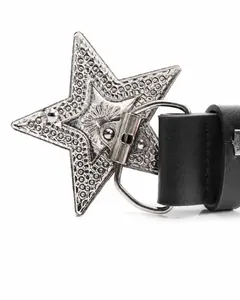 Detail view of the star-shaped alloy buckle with secure snap button on a black punk belt