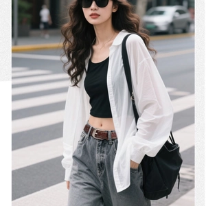 Detail of vintage brown rivet belt paired with high waist grey jeans for a stylish look