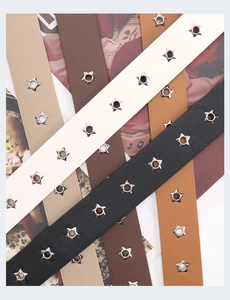 Detail view of punk style belts with star metal eyelets in black, beige, and brown colors
