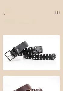 Detail view of black punk belt with triple rows of silver metal eyelets and a square buckle