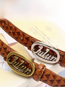 Close-up of caramel brown leather belts with diamond lattice pattern and metal buckle