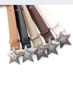 Detail of five punk style belts with vintage silver star buckles and star-shaped metal studs
