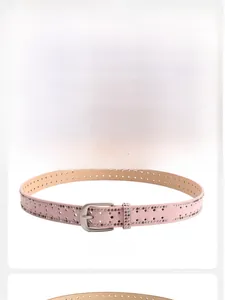 Detail view of black and pink belts with cross-shaped cutouts and metal rivets