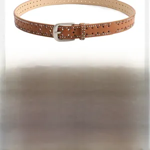 Detailed view of camel and white leather belts with star punch holes and silver studs