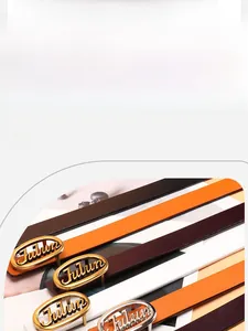 Close-up of golden oval buckle with letter engraving on premium leather belts