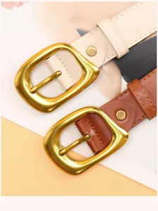 Detail view of stylish alloy square buckle belts in beige and brown faux leather