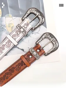 Macro detail of vintage embossed leather belts with ornate floral silver buckles