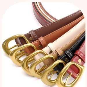 Flat lay of retro thin leather belts in five colors with matte gold D-shaped buckles