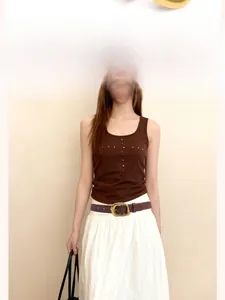 Detail showing high-quality vintage gold oval buckle on a dark brown matte leather belt