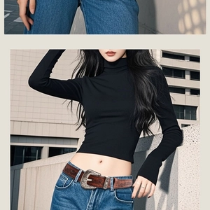 Close-up of a vintage embossed dark brown leather belt with a silver metallic buckle on jeans