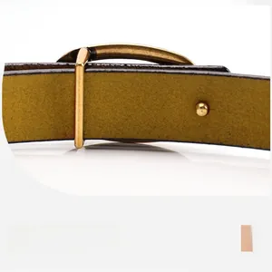 Macro shot of premium mustard yellow leather belt with high-quality gold metal buckle