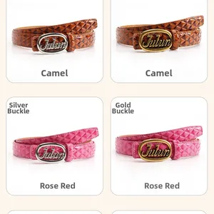 Detail of camel and rose red leather belts with embossed diamond patterns and metal buckles