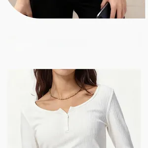 Detailed close-up of a minimalist gold chain necklace worn with a white ribbed long-sleeve top