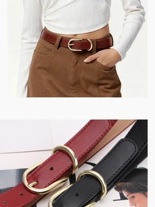 Detail of red and black leather belts for women with elegant golden oval buckles