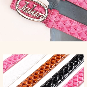 Close-up of stylish glossy patent leather belts with diamond patterns and oval metal buckles