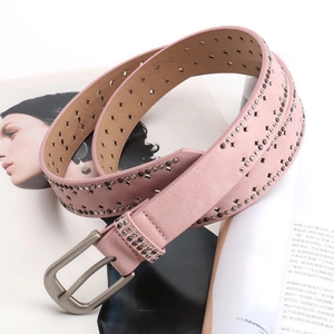 Pink frosted leather belt for women with metal studs and star cutouts on a magazine