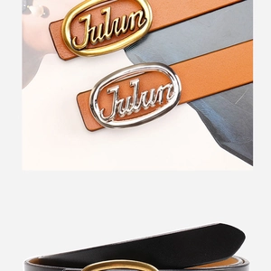 Macro shot of oval metal buckle with Julun lettering on premium leather belt for women