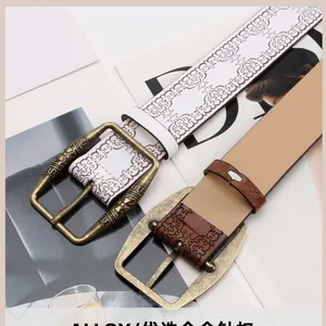 Close-up of vintage patterned leather belt with engraved antique bronze alloy buckle