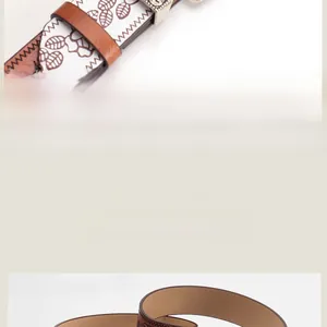 Detailed macro view of the vintage floral embossed pattern on a wide brown leather belt