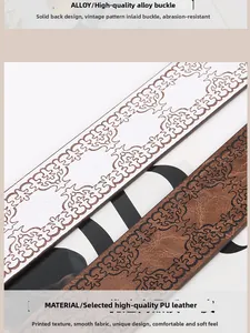 Close-up of floral embossed texture on vintage white and brown leather belts
