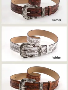 Detail of vintage western floral embossed leather belts in camel and white with metal buckles