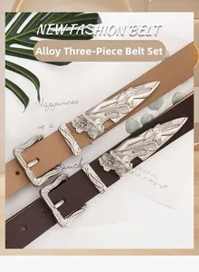 Close-up of Western vintage leather belts with engraved alloy buckles and floral patterns
