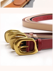 Detail view of colorful faux leather belts with polished gold rectangular metal buckles