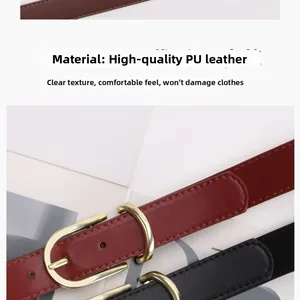 Detailed view of red and black PU leather belts with high-quality gold metal buckles