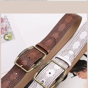 Detail of vintage embossed leather belts with antique bronze buckles for women