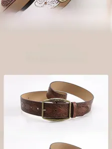 Detail view of coffee vintage faux leather belt with floral embossing and bronze buckle