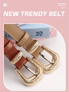 Detail of trendy slim belts with textured gold crescent buckles in khaki and brown