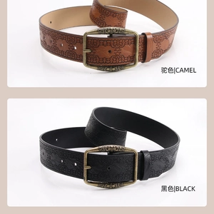 Detailed view of camel and black vintage belts with embossed floral mandala patterns