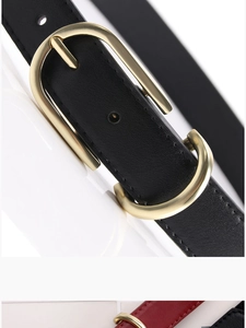Macro detail of high-quality lychee textured leather belts with golden oval metal buckles